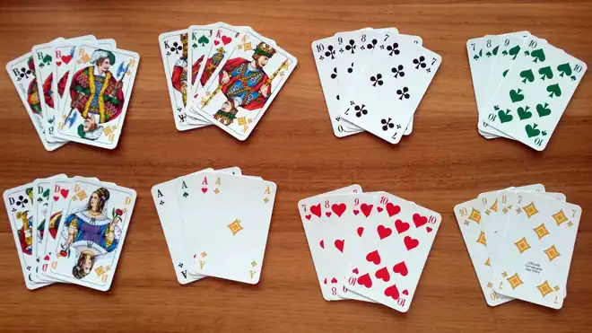  Three players with German Skat cards and score sheets mid-play.
