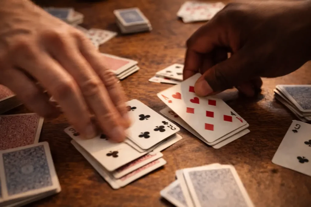 Hands moving quickly to play cards in a fast-paced Nerts round.